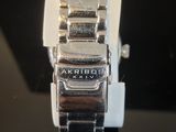 a close up of a watch on a black surface