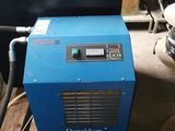an image of a blue machine sitting on top of a wooden floor