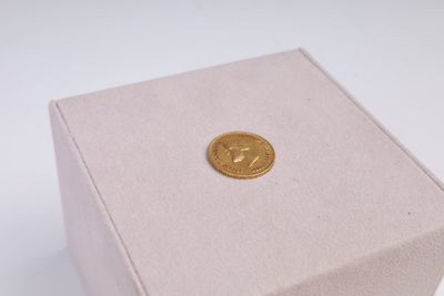 a small box with a gold coin in it