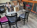 many chairs and tables in a room with boxes on the table
