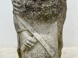 an old statue of a woman holding a baby in her arms