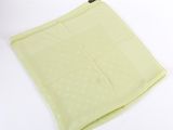 une pochette vert citron à pois blancs sur fond blanc
