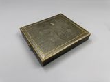 an old book sitting on top of a white table