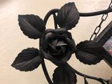 a clock with a rose on it sitting on a table