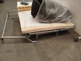 a small bed with a mattress on it in a room