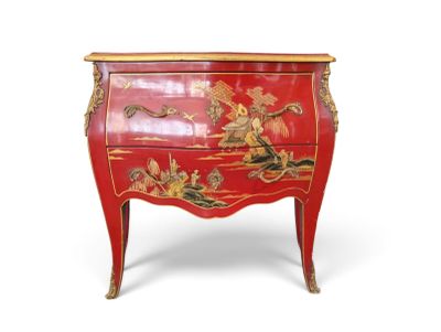 une commode rouge décorée d'un tableau