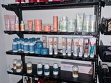 a shelf full of cosmetic products in the corner of the room