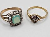two rings, one with a green stone and the other with diamonds