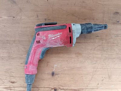 a drill that is sitting on a wooden table