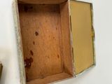 a small wooden box with a mirror on the wall