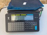 a laptop sitting on top of a table with a bag on top of it