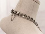 a close up of a mannequin with a chain on it