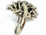 sterling silver ring with a flower design on the center