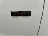 a close up of a badge on a white car