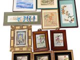 a lot of framed pictures on the wall of this room