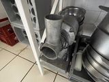 pots and pans are stacked on a metal shelf in a kitchen