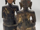 pair of antique wooden buddha statues on white background
