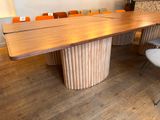 a wooden table with chairs around it in a room