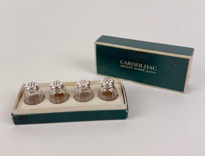three salt and pepper shakers in a box on a table