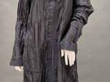 an image of a mannequin dressed in a black coat and black tights