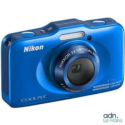blue digital camera sitting on a white surface with a white background