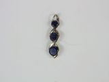a close up of a blue stone pendant on a white surface