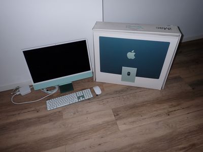 a computer and a keyboard on the floor next to a box