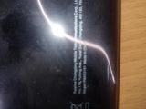 a close up of a cell phone on a table with a blurry background