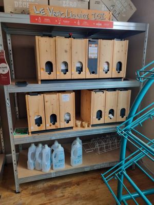 a shelf with several boxes of cleaning products on top of it