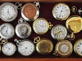 many different types of pocket watches in a box
