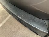 a close up of a car ' s bumper with scratches on it