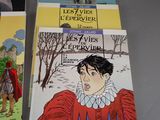several children ' s books are lined up on a table