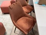 two chairs and a table in a room with boxes on the floor