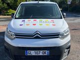 a white van with a rainbow sticker on it parked in a parking lot