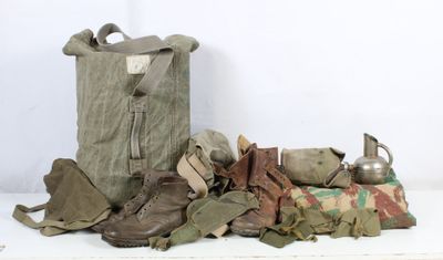 a large bag of military items on a white table