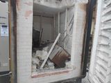 a broken window in the wall of a building