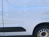 a white van parked in a parking lot next to a building