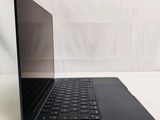 an open laptop computer sitting on top of a white surface