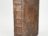 an old book sitting on top of a white surface