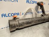 a close up of a metal pipe with a hose attached to it