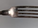 a fork that has a metal handle on it