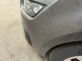 a close up of a car ' s front bumper with a denting on it
