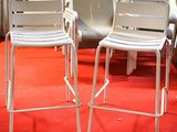 several white chairs and a table in a room with a red carpet