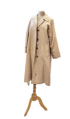 un trench-coat posé sur un mannequin, devant un fond blanc