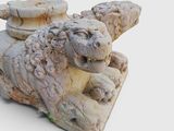 a statue of a lion that is sitting on top of a table