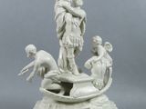 a white statue of a man and a woman on a boat