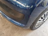 a blue car that is parked in a garage