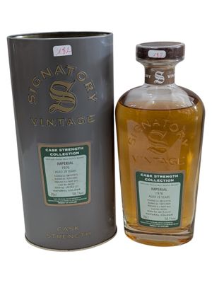 a bottle of whisky sitting next to a metal container