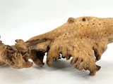 a wooden sculpture of a bear that is on a white surface