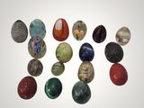 a lot of different colored marbles on a white surface